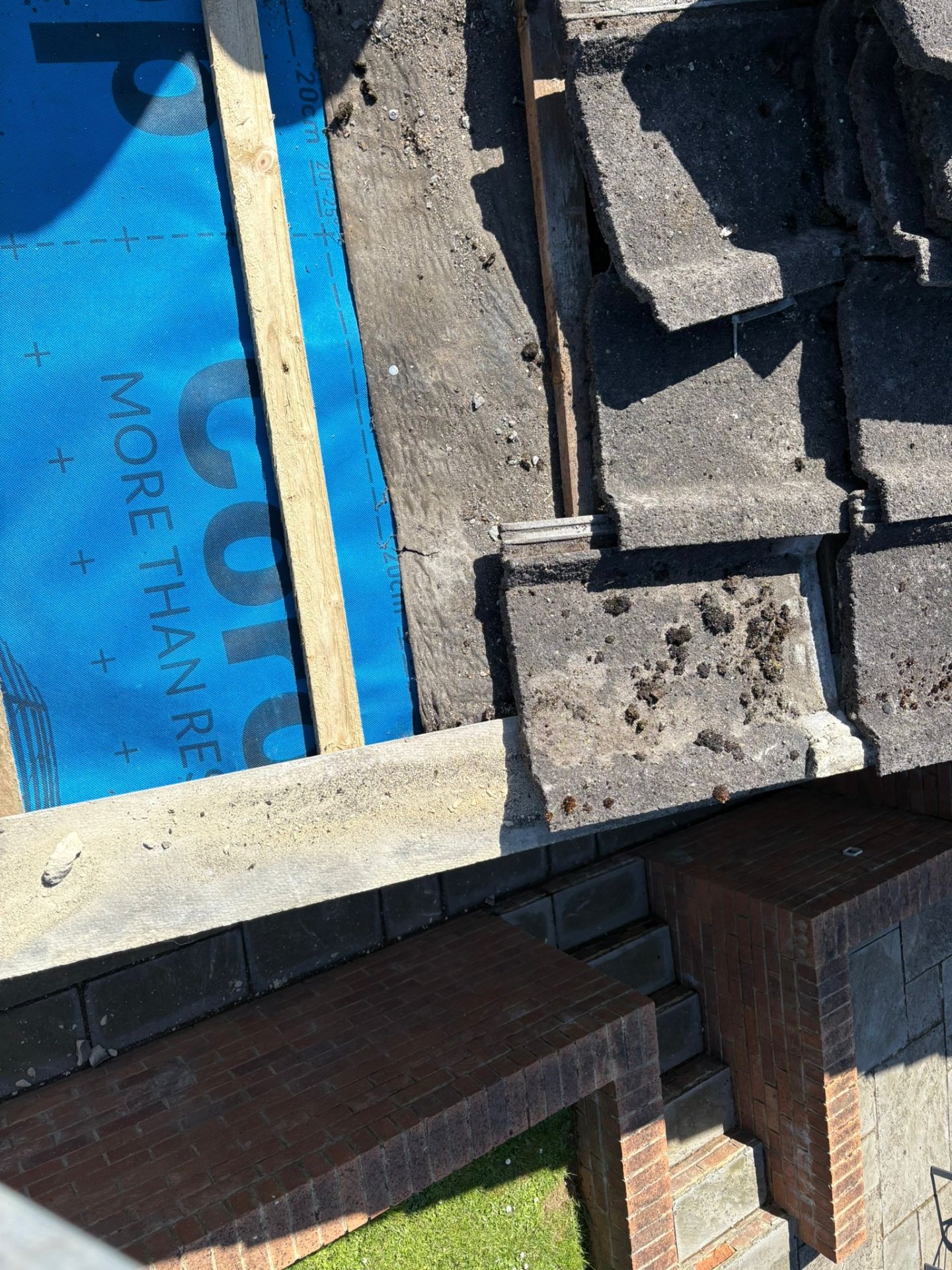 Aerial view of a pitched roof under construction with new membrane and battens